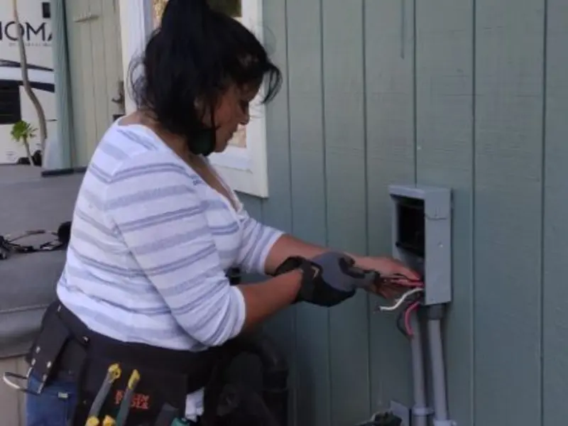 Licensed electrician wiring an exterior subpanel in Firebaugh